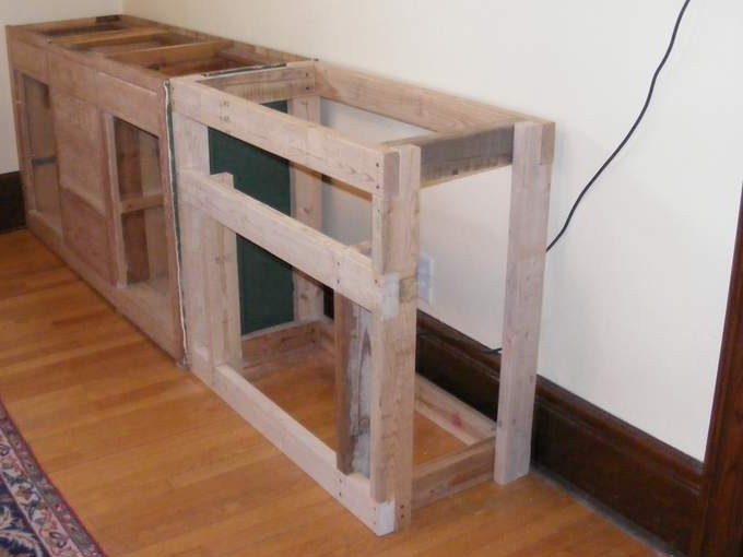 The frame is narrower than the cabinet to allow for the thickness of the tile backing.
