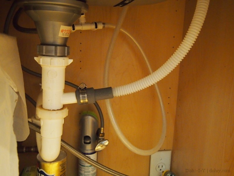 The waste pipe from the dishwasher connects to the sink waste pipe. The electrical outlet at lower right is on a dedicated circuit.