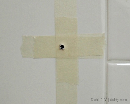 Apply tape over the drilling spot to further protect the tile.